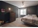 Comfortable bedroom with a dark accent wall, and a ceiling fan at 10760 Independence Way, Carmel, IN 46032