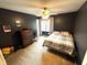 This bedroom has neutral carpet, dark colored walls, and lots of natural light at 10760 Independence Way, Carmel, IN 46032