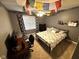 This cozy bedroom features a ceiling fan, neutral carpet, and pops of color at 10760 Independence Way, Carmel, IN 46032