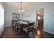 Elegant dining room with modern chandelier, wooden table set, and blue walls at 10760 Independence Way, Carmel, IN 46032