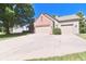 View of the home featuring an attached two car garage and a long driveway at 10760 Independence Way, Carmel, IN 46032