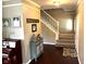 Welcoming foyer showcasing hardwood floors, a staircase, and decorative accents at 10760 Independence Way, Carmel, IN 46032