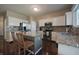 Well-lit kitchen featuring granite countertops, stainless steel appliances, and bar stool seating at 10760 Independence Way, Carmel, IN 46032