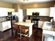 Eat-in kitchen featuring granite countertops, stainless steel appliances, and white cabinetry at 10760 Independence Way, Carmel, IN 46032