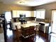 Well-equipped kitchen featuring an island with seating, granite countertops, and modern appliances at 10760 Independence Way, Carmel, IN 46032