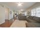 Open-concept living room with hardwood floors and access to kitchen at 10760 Independence Way, Carmel, IN 46032