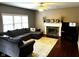 Comfortable living room with a large sectional sofa, fireplace, and plush rug at 10760 Independence Way, Carmel, IN 46032