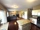 Open concept living area with a fireplace, ceiling fan, and easy access to the eat-in kitchen at 10760 Independence Way, Carmel, IN 46032