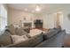 Cozy living room with a fireplace, plush sofa, and hardwood floors at 10760 Independence Way, Carmel, IN 46032