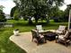 Outdoor seating area with chairs surrounding a fire pit, complemented by a lush green lawn at 10760 Independence Way, Carmel, IN 46032