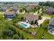 Private backyard featuring a sparkling pool, patio area, and lush greenery at 1102 Clearwell Dr, Greenwood, IN 46143
