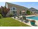 Backyard pool featuring lounge chairs and a hot tub surrounded by lush landscaping at 1102 Clearwell Dr, Greenwood, IN 46143