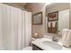 Cozy bathroom with white shower curtain and vanity with mirror at 1102 Clearwell Dr, Greenwood, IN 46143