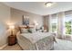 Bright bedroom with patterned bedding, a window seat, and natural light at 1102 Clearwell Dr, Greenwood, IN 46143