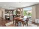 Open dining area with hardwood floors, modern lighting, and sliding glass doors overlooking the pool at 1102 Clearwell Dr, Greenwood, IN 46143