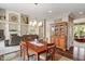 Dining area with hardwood floors, decorative rug, chandelier, and views of the living room and fireplace at 1102 Clearwell Dr, Greenwood, IN 46143