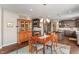Dining area showcasing hardwood floors connecting an antique hutch to the spacious kitchen at 1102 Clearwell Dr, Greenwood, IN 46143