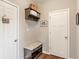 Functional entryway featuring hardwood floors, a storage bench, and coat hooks for organization at 1102 Clearwell Dr, Greenwood, IN 46143