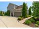 Lovely two-car garage showcasing meticulously kept landscaping at 1102 Clearwell Dr, Greenwood, IN 46143