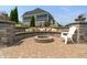 A backyard stone fire pit seating area with a brick-paved patio, perfect for outdoor entertaining at 1102 Clearwell Dr, Greenwood, IN 46143