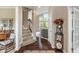 Inviting foyer with hardwood floors, staircase, and view into the bright living room at 1102 Clearwell Dr, Greenwood, IN 46143