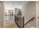 Hallway with wooden railings, carpet, and a view of the foyer below at 1102 Clearwell Dr, Greenwood, IN 46143