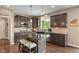 Well-equipped kitchen featuring dark cabinets, granite countertops, stainless steel appliances, and hardwood floors at 1102 Clearwell Dr, Greenwood, IN 46143