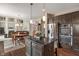 Modern kitchen with stainless steel appliances, granite countertops, large island, and hardwood floors at 1102 Clearwell Dr, Greenwood, IN 46143