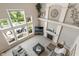 Spacious living room with floor-to-ceiling windows, a fireplace, and modern furniture at 1102 Clearwell Dr, Greenwood, IN 46143