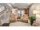 Carpeted basement living room with chairs, table, and decor at 1102 Clearwell Dr, Greenwood, IN 46143