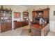 Spacious home office with custom built-in bookshelves, a large desk, and carpeted floors at 1102 Clearwell Dr, Greenwood, IN 46143