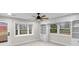 Bedroom with built-in bookcases, cabinets, large windows, and a ceiling fan at 11035 W Lakeshore Dr, Carmel, IN 46033