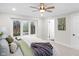 Sun-filled bedroom with large window offering backyard views, ceiling fan, and plush bedding at 11035 W Lakeshore Dr, Carmel, IN 46033