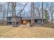 Charming two-story home with a modern gray exterior, black roof, and beautiful wooded front yard at 11035 W Lakeshore Dr, Carmel, IN 46033