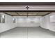 Clean garage interior with white walls, grey floor, and storage cabinets at 11035 W Lakeshore Dr, Carmel, IN 46033