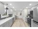 Bright, updated kitchen with modern appliances, herringbone backsplash, and sleek gray cabinetry at 11035 W Lakeshore Dr, Carmel, IN 46033