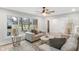 Living room with natural light, neutral walls and trim, hardwood floors and stairs to second level at 11035 W Lakeshore Dr, Carmel, IN 46033