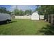 Large backyard with a well-maintained fence and a charming shed for extra storage at 1125 S Drexel Ave, Indianapolis, IN 46203