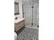 Bathroom featuring a glass-enclosed shower, black and white tile, and a wood vanity at 1125 S Drexel Ave, Indianapolis, IN 46203