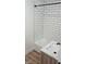 Updated bathroom with subway tile surround, modern fixtures, and a stylish vanity at 1125 S Drexel Ave, Indianapolis, IN 46203