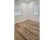 Bright bedroom showcasing wood-look flooring, neutral walls, and natural light from dual windows at 1125 S Drexel Ave, Indianapolis, IN 46203
