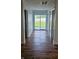 Inviting hallway featuring wood-look flooring and a bright glass sliding door leading to the backyard at 1125 S Drexel Ave, Indianapolis, IN 46203