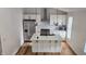 Open kitchen featuring a stylish island, stainless steel appliances, and modern backsplash at 1125 S Drexel Ave, Indianapolis, IN 46203