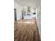 Open-concept living area with wood-look flooring and kitchen view at 1125 S Drexel Ave, Indianapolis, IN 46203