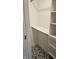 Bright walk-in closet with custom shelving, drawers, and striking black and white patterned flooring at 1125 S Drexel Ave, Indianapolis, IN 46203