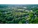 An aerial shot showcases a residential area nestled among verdant trees and greenery at 11510 Ralston Ave, Carmel, IN 46032