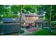 Spacious backyard view showcasing a deck, patio, sunroom, lush greenery, and exterior of the home at 11510 Ralston Ave, Carmel, IN 46032