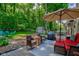 Inviting backyard with outdoor seating, a grill, a hot tub, an umbrella, and lush greenery for relaxation at 11510 Ralston Ave, Carmel, IN 46032
