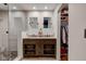 Elegant bathroom featuring a double vanity, glass shower, and convenient closet with ample storage at 11510 Ralston Ave, Carmel, IN 46032