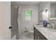 Well-lit bathroom features a shower with subway tile, modern fixtures, and updated vanity at 11510 Ralston Ave, Carmel, IN 46032